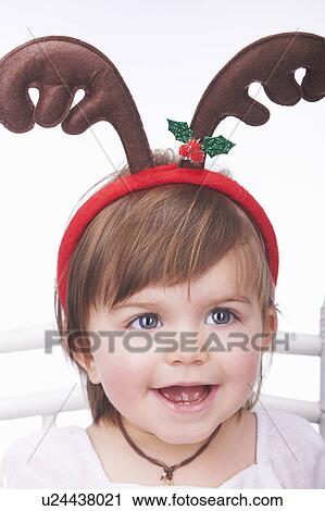 Baby girl wearing reindeer antlers View Large Photo Image Stock Image - Baby girl wearing reindeer antlers. Fotosearch