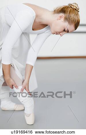 Ballet dancer examining hurt ankle View Large Photo Image Stock Photograph - Ballet dancer examining hurt ankle. Fotosearch