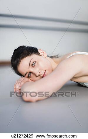 Ballet dancer on floor in studio View Large Photo Image Stock Photo - Ballet dancer on floor in studio. Fotosearch