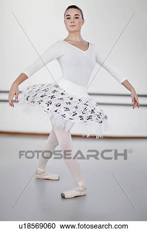 Ballet dancer posing in studio View Large Photo Image Stock Image - Ballet dancer posing in studio. Fotosearch