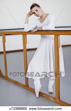 Ballet dancer standing at barre View Large Photo Image Stock Photo - Ballet dancer standing at barre. Fotosearch