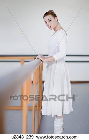 Stock Photo - Ballet dancer standing at barre. Fotosearch