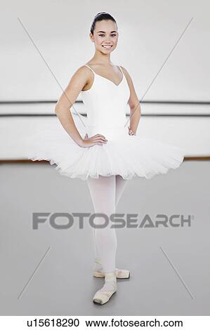 Ballet dancer standing in studio View Large Photo Image Stock Image - Ballet dancer standing in studio. Fotosearch