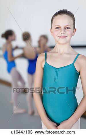 Stock Image - Ballet dancer standing in studio. Fotosearch