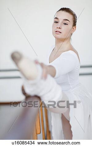 Ballet dancer stretching at barre View Large Photo Image Picture - Ballet dancer stretching at barre. Fotosearch