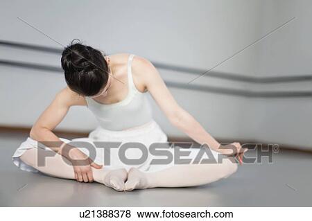 Ballet dancer stretching in studio View Large Photo Image Stock Photo - Ballet dancer stretching in studio. Fotosearch