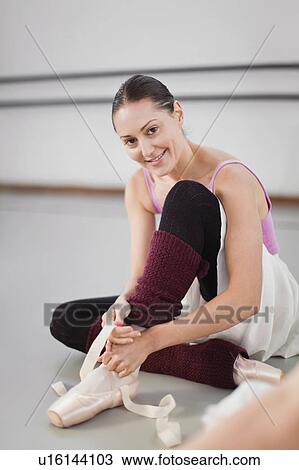 Ballet dancer tying her shoe in studio View Large Photo Image Stock Image - Ballet dancer tying her shoe in studio. Fotosearch