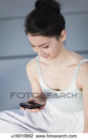Ballet dancer using cell phone View Large Photo Image Stock Image - Ballet dancer using cell phone. Fotosearch