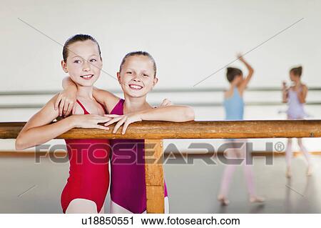 Ballet dancers embracing at barre View Large Photo Image Stock Image - Ballet dancers embracing at barre. Fotosearch