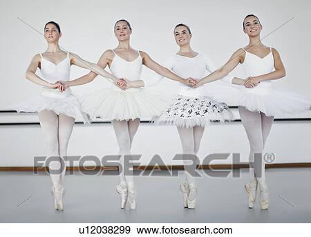 Stock Photo - Ballet dancers holding hands in studio. Fotosearch