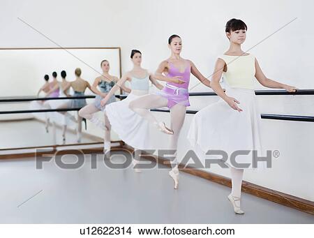 Picture - Ballet dancers posing at barre. Fotosearch