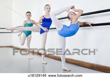 Ballet dancers posing at barre View Large Photo Image Stock Photo - Ballet dancers posing at barre. Fotosearch