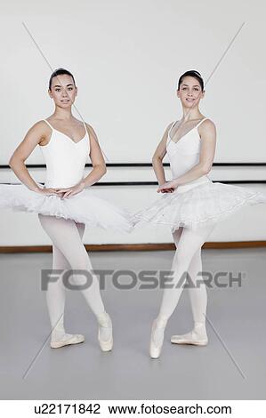 Stock Image - Ballet dancers posing together in studio. Fotosearch