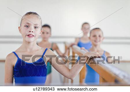 Ballet dancers standing at barre View Large Photo Image Stock Image - Ballet dancers standing at barre. Fotosearch