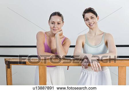 Ballet dancers standing at barre View Large Photo Image Stock Image - Ballet dancers standing at barre. Fotosearch