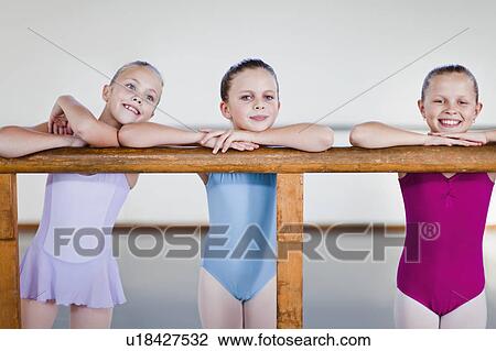 Ballet dancers standing at barre View Large Photo Image Stock Image - Ballet dancers standing at barre. Fotosearch