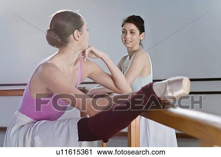 Ballet dancers stretching at barre View Large Photo Image Stock Image - Ballet dancers stretching at barre. Fotosearch