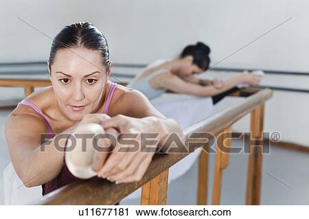 Ballet dancers stretching at barre View Large Photo Image Stock Image - Ballet dancers stretching at barre. Fotosearch