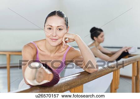Ballet dancers stretching at barre View Large Photo Image Stock Photo - Ballet dancers stretching at barre. Fotosearch