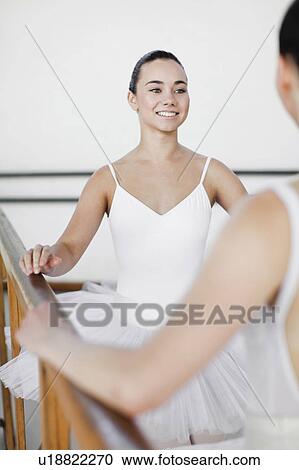 Ballet dancers talking at barre View Large Photo Image Stock Image - Ballet dancers talking at barre. Fotosearch
