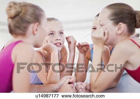 Ballet dancers talking on studio floor View Large Photo Image Stock Photo - Ballet dancers talking on studio floor. Fotosearch