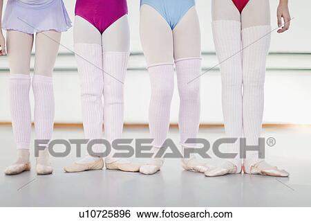 Stock Photograph - Ballet dancers wearing leg warmers. Fotosearch