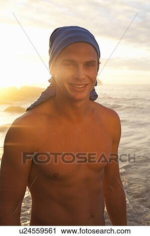Bare-chested man on beach View Large Photo Image Stock Image - Bare-chested man on beach. Fotosearch