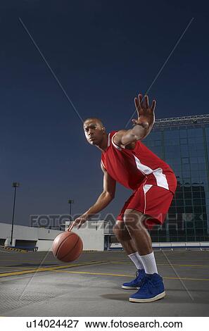 Basketball player dribbling on rooftop View Large Photo Image Stock Photo - Basketball player dribbling on rooftop. Fotosearch