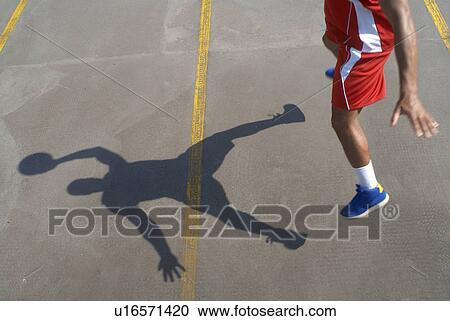 Basketball player jumping with ball View Large Photo Image Stock Image - Basketball player jumping with ball. Fotosearch