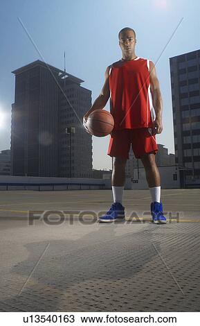 Basketball player with ball on rooftop View Large Photo Image Stock Image - Basketball player with ball on rooftop. Fotosearch