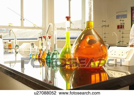 Stock Image - Beakers of liquid in factory. Fotosearch