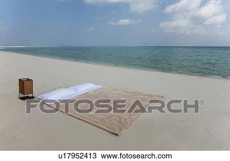 Stock Image - Bed made on tropical beach. Fotosearch