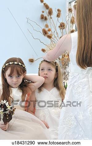 Stock Image - Bored flower girls in wedding. Fotosearch