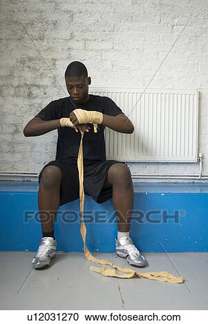 Boxer wrapping his hand in gym View Large Photo Image Stock Image - Boxer wrapping his hand in gym. Fotosearch