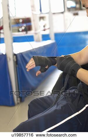 Boxer wrapping his hands in gym View Large Photo Image Stock Photograph - Boxer wrapping his hands in gym. Fotosearch