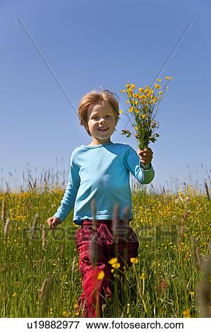 Stock Photo - Boy carrying bunch of flowers. Fotosearch