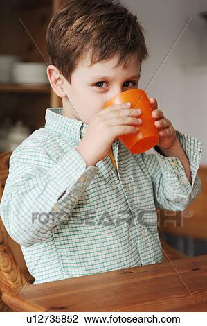 Stock Image - Boy drinking out of plastic cup. Fotosearch