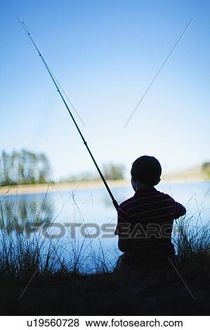 Stock Photo - Boy fishing in lake. Fotosearch