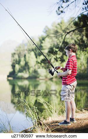 Stock Photo - Boy fishing in lake. Fotosearch