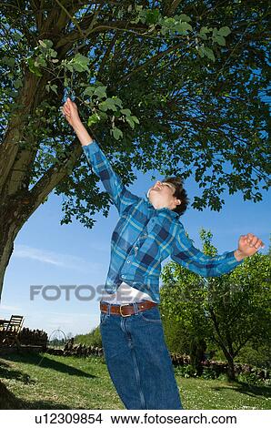 Boy jumping in backyard View Large Photo Image Picture - Boy jumping in backyard. Fotosearch