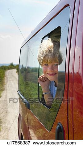 Boy peering out car window View Large Photo Image Stock Photo - Boy peering out car window. Fotosearch