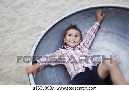 Boy playing at playground View Large Photo Image Stock Photo - Boy playing at playground. Fotosearch
