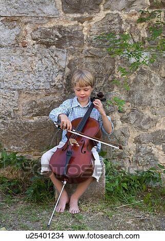 Boy playing cello outdoors View Large Photo Image Picture - Boy playing cello outdoors. Fotosearch