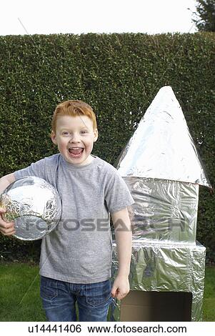 Boy playing with cardboard spaceship View Large Photo Image Stock Photograph - Boy playing with cardboard spaceship. Fotosearch