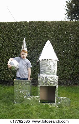 Boy playing with cardboard spaceship View Large Photo Image Stock Photography - Boy playing with cardboard spaceship. Fotosearch