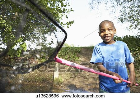Boy playing with fishing net View Large Photo Image Stock Photograph - Boy playing with fishing net. Fotosearch