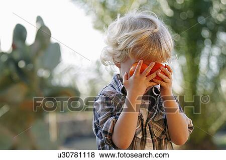 Boy playing with oranges outdoors View Large Photo Image Stock Photo - Boy playing with oranges outdoors. Fotosearch
