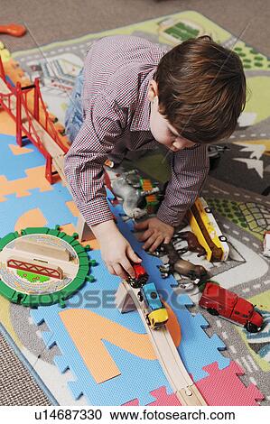 Boy playing with toy cars View Large Photo Image Stock Image - Boy playing with toy cars. Fotosearch
