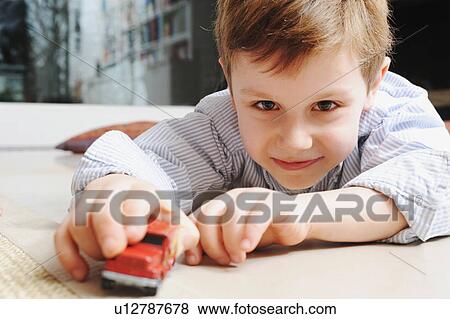 Boy playing with toy cars View Large Photo Image Stock Photo - Boy playing with toy cars. Fotosearch
