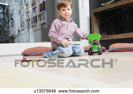 Boy playing with toy cars View Large Photo Image Stock Photo - Boy playing with toy cars. Fotosearch